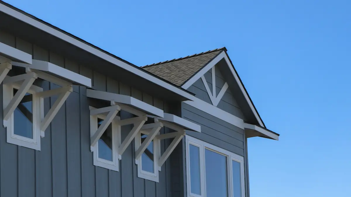 The gable and bracketed window bay of a newer board-and-batten house - Leak Detection in Canyon Hill